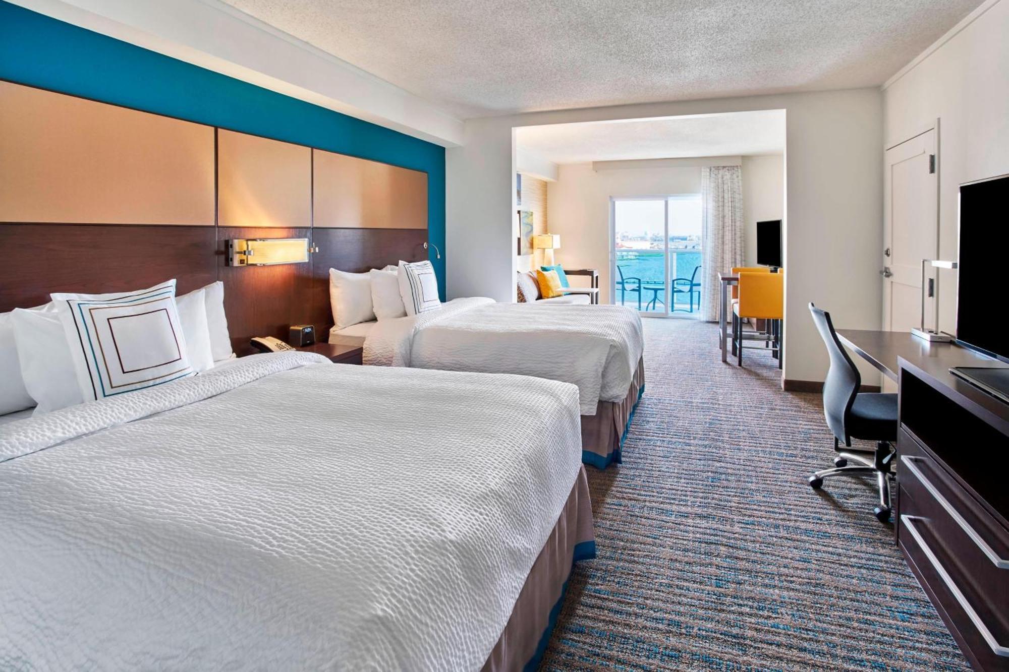Queen Studio Suite with Balcony and Water View - Mobility and Hearing Accessible with Roll-in Shower